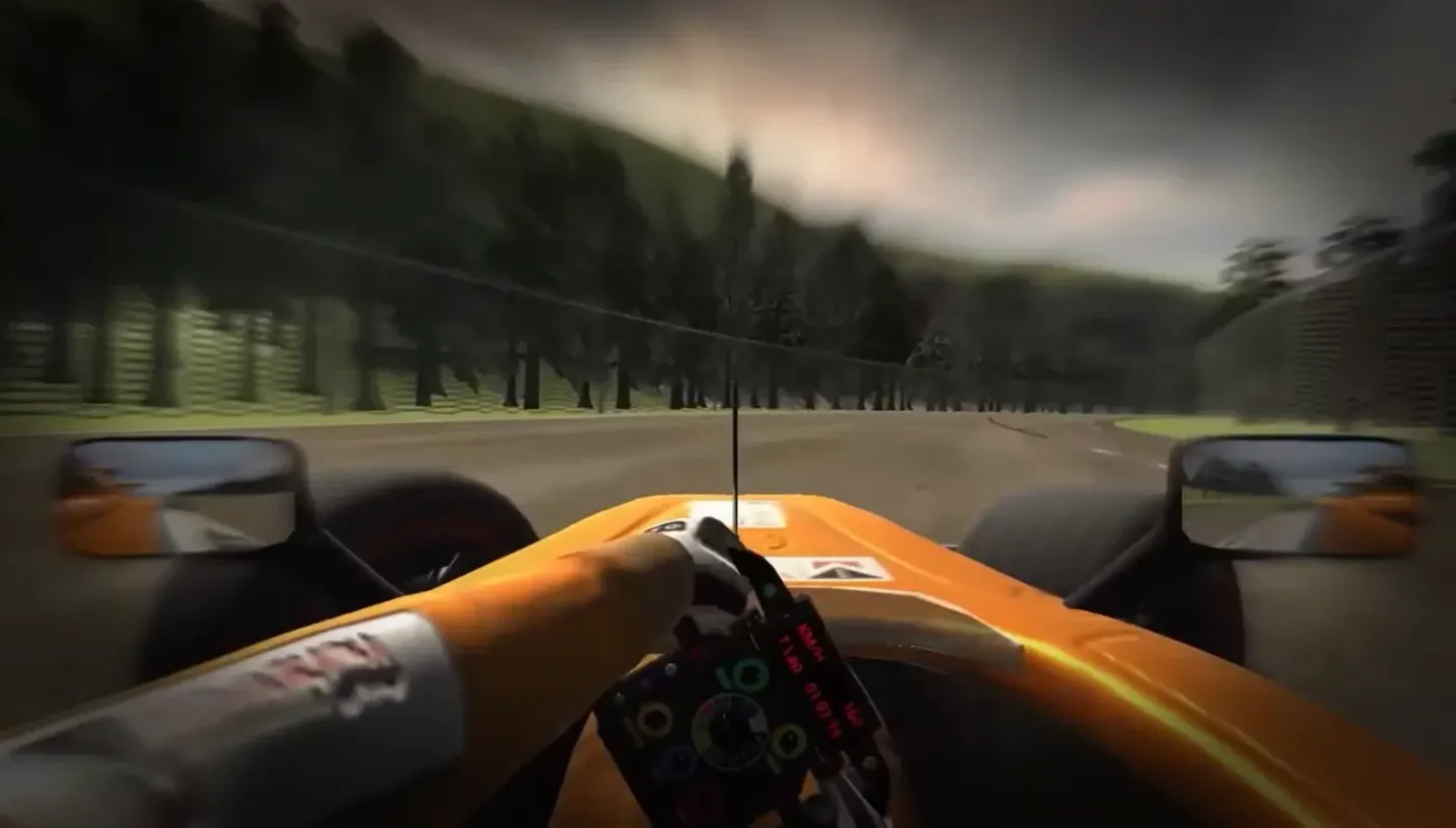 Vista en primera persona desde el habitáculo del monoplaza en un circuito entre bosques, con la pantalla del volante que muestra velocidad y tiempo de vuelta